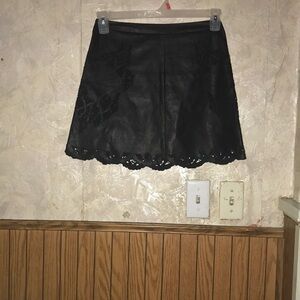 Cute black faux leather mini skirt with rose cutouts